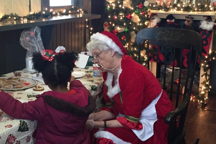 Santa Claus speaks with young riders aboard the Summerville Santa Special holiday train.