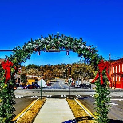 Holiday archway decorated with garland and lights at the Summerville Depot entrance.