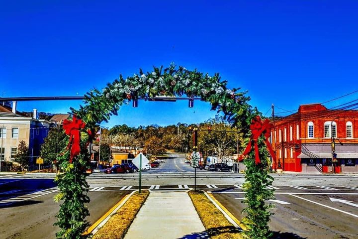 Holiday archway decorated with garland and lights at the Summerville Depot entrance.