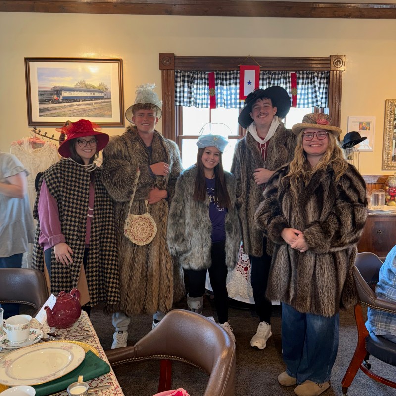 Guests dressed in vintage winter attire inside the Homefront Tea Room during Christmas Tea at TVRM.