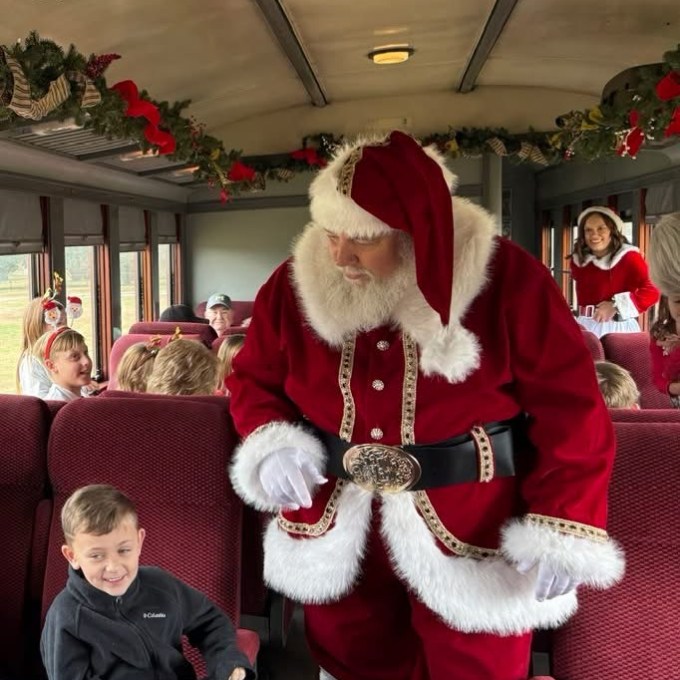 Santa visiting children aboard a decorated Tennessee Valley Railroad Museum Christmas train