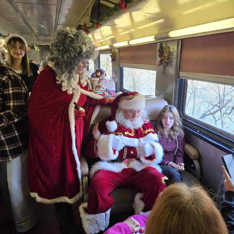Santa and Mrs. Claus greeting children aboard a Tennessee Valley Railroad Museum holiday train