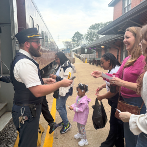 TVRM conductor assisting a family boarding the train in Chattanooga