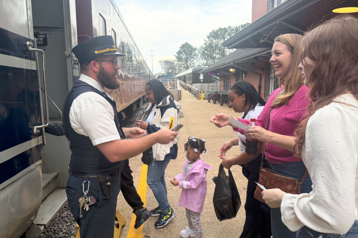 TVRM conductor assisting a family boarding the train in Chattanooga